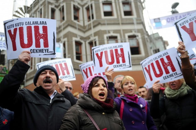 People hold placards reading ‘Shame to thieves with Boxes’ during a demostration on December 29, 2013 in Istanbul against corruption and the Government. Turkish Prime Minister Recep Tayyip Erdogan lashed out at the judiciary as he tried to tamp down a corruption probe that has shaken his government and sparked a new wave of anti-government protests. (Ozan Kose/AFP/Getty Images)