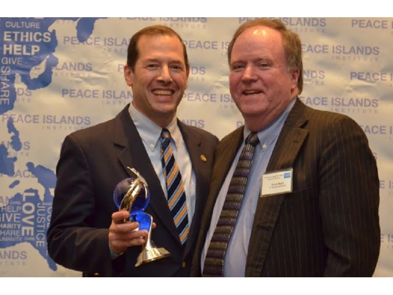 State Rep. Andy Fleischmann receives the Statesman of the Year Award standing with Rep. Kevin Ryan (right). Submitted photo