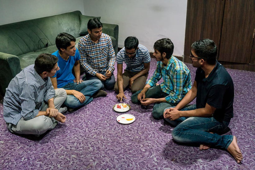 Indian and Turkish students sharing plates of fruits. New Delhi - India, 2016