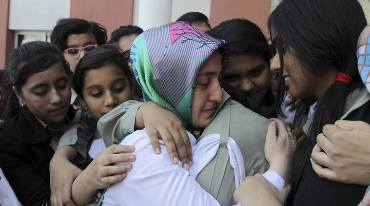 Pakistani students of the Pak-Turk International school comfort their Turkish teacher in Lahore, Pakistan, Nov. 17, 2016. (AP Photo/K.M. Chaudhry)