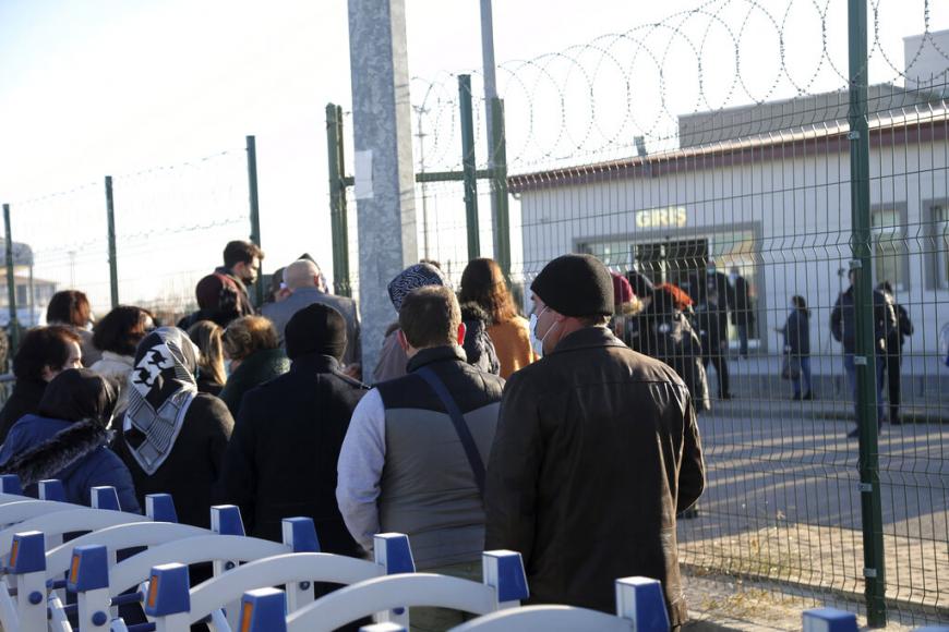 People wait outside a courthouse before the trial of 475 defendants, including generals and fighter jet pilots, in Sincan, Ankara, Turkey, Thursday, Nov. 26, 2020.  © 2020 AP Photo